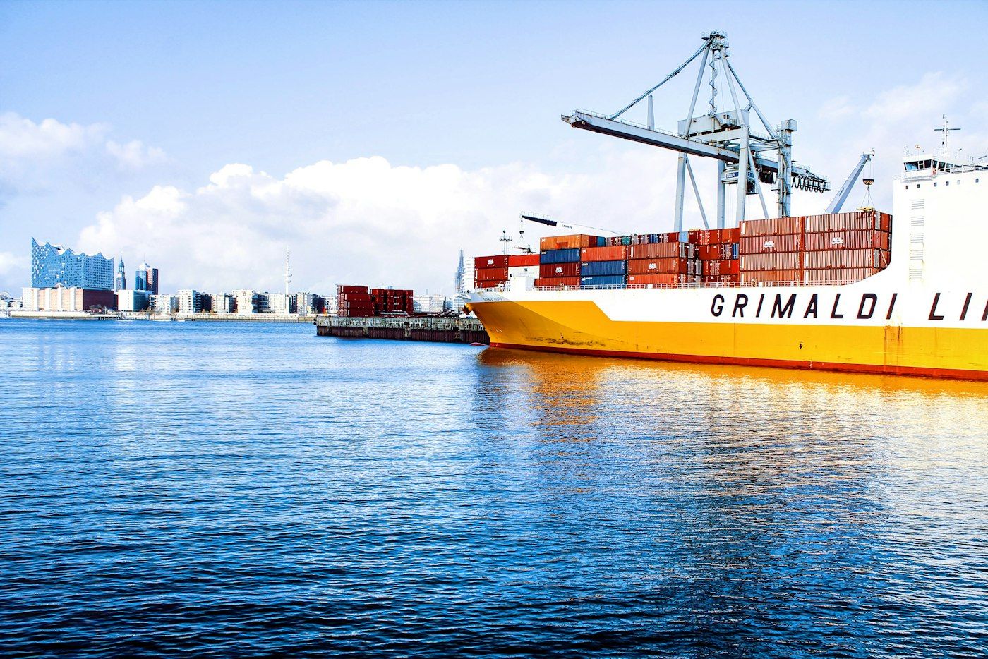 Cargo ship being loaded with shipping containers at port